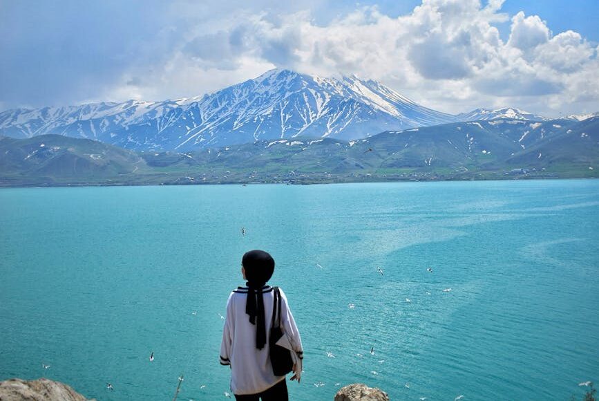 a woman standing on top of the mountain